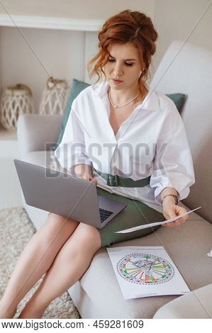 A Woman With A Laptop Is Studying Human Design. The Concept Of Studying Esoteric Sciences. Studying 