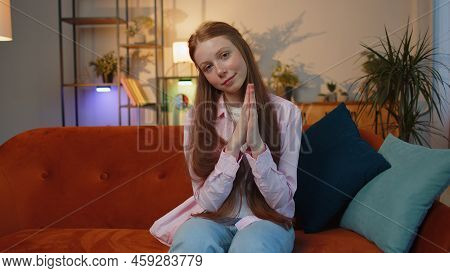 Please, God Help. Young Redhead Child Girl Praying Sincerely With Folded Arms, Looking Upward And Ma