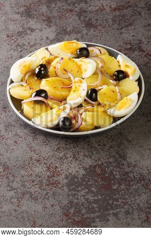 Salata Orientala Potato Salad With Onions, Olives And Boiled Eggs Close-up On A Plate On The Table. 