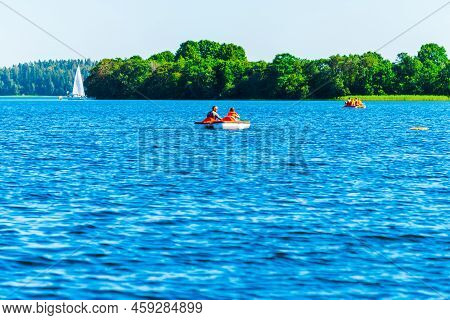 People Enjoy Water Activities With Water Bike In The Nature Lake.copy Space.plateliai,lithuania.08-0