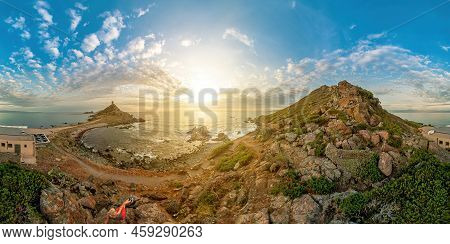 360 Degrees Panorama View Of A Tourist Woman Sitting On Top In Punta Parata At Sunset By The Sanguin