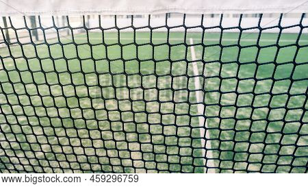 Net And Part Of Green Synthetic Grass Paddle Tennis Court Indoor Without People