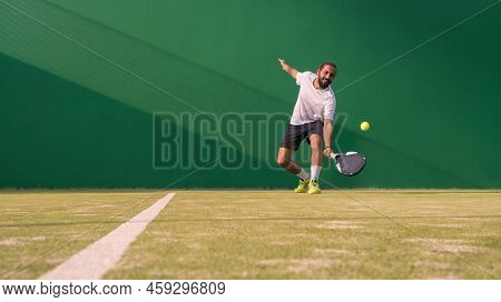 Net And A Part Of Green Synthetic Grass Paddle Tennis Court Indoor Without People. Paddle Is A Racqu