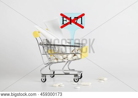Titanium Dioxide, E171, Dangerous Additive Concept. Gum, Pills, Toothpaste, Cream In Basket And Sign