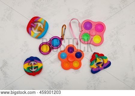 Different Popular Colorful Children's Toys (spinner, Simple Dimple, Pop It And Snapperz Toys) On Lig
