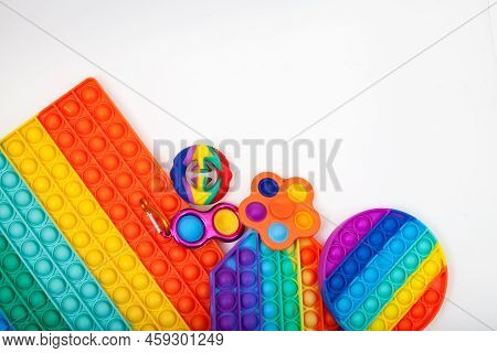 Trendy Toys (pop It, Push Pop Fidget Toy, Bubble Fidget, Snapperz, Simple Dimple) On Light Backgroun