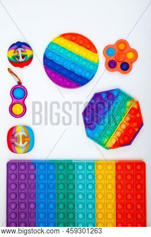 Different Trendy Pop It Fidget Toys On White Background. Popular Silicone Colorful Anti Stress Toys 