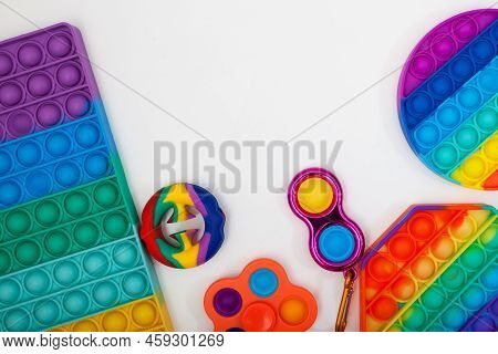 Trendy Silicone Toys (snapperz, Pop It, Simple Dimple) On White Background Selective Focus, Copy Spa
