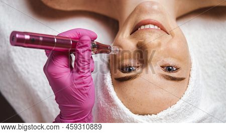 Cosmetician Making Anti-aging Therapy To The Patients Face Using Dermapen. Beauty Treatment. Beauty 