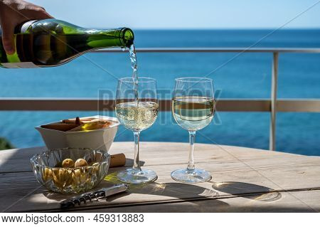 Pouring Of Txakoli Or Chacolí Slightly Sparkling Very Dry White Wine Produced In The Spanish Basque