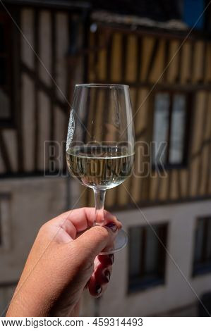 Tasting Of White Grand Cru Classe Chablis Wine With Old French Houses On Background, Burgundy, Franc
