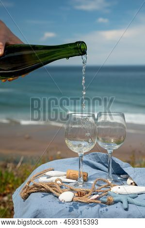 Pouring Of Txakoli Or Chacolí Slightly Sparkling Very Dry White Wine Produced In The Spanish Basque