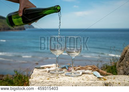 Pouring Of Txakoli Or Chacolí Slightly Sparkling Very Dry White Wine Produced In The Spanish Basque