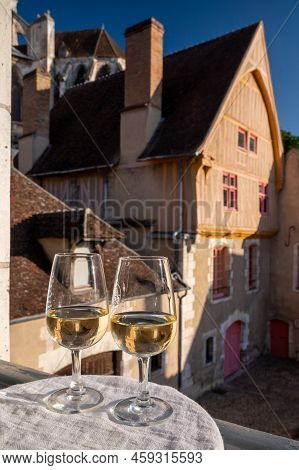 Tasting Of White Grand Cru Classe Chablis Wine With Old French Houses On Background, Burgundy, Franc