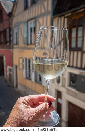 Tasting Of White Grand Cru Classe Chablis Wine With Old French Houses On Background, Burgundy, Franc