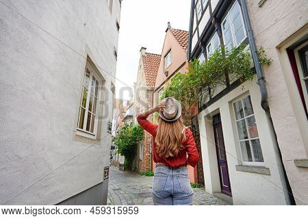 Attractive Traveler Woman Walking In Schnoor Neighborhood, Bremen, Germany