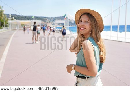 Portrait Of Attractive Fashion Woman Turns Around And Smiling At Camera Walking Along Promenade Des 