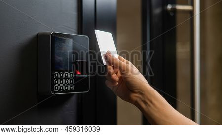 A Woman Opens The Door With A Plastic Card. Modern Keyless Entry Lock.