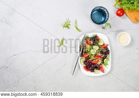 Healthy Vegetable Salad With Fresh Salad Leaves, Arugula, Cherry Tomato, Cucomber And Parsley In Pla