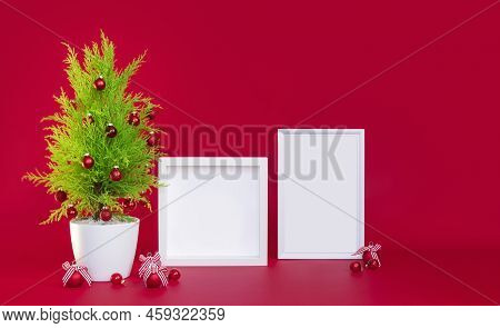 Christmas Mock-up, On A Red Background A Small Christmas Tree And Two White Frames For Te Xt