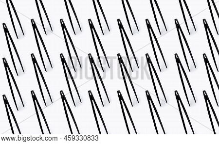 Pattern Of Black Plastic Toongs On White Background.
