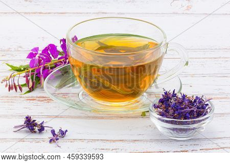 Still Life Of Fireweed Herbal Tea In Glass Cup With Fresh And Dry Purple Fireweed Flowers Against Li