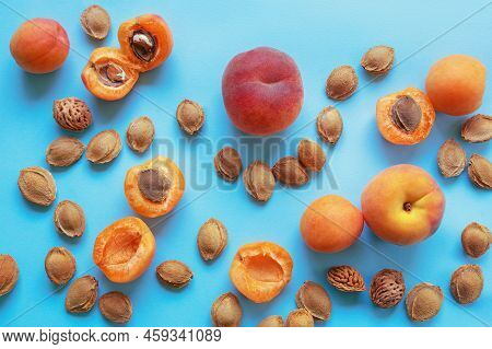 Bright Apricots And Peaches And Fruit Stones On Blue