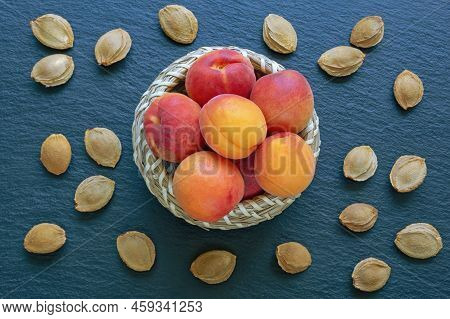 Ripe Apricots And Apricot Stones On Dark Table. Flat Lay