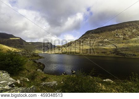 Beautiful Lake And Mountains Sun And Cloud. Ogwen Cottage, Snowdonia, Wales.