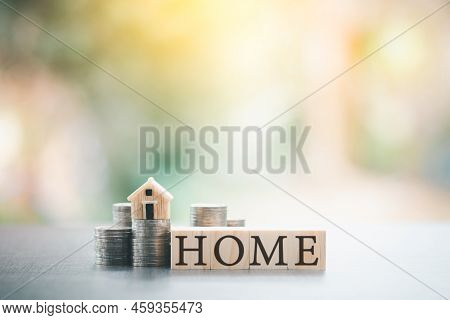 House Stack Of Coins And Wooden Blocks On The Table,financial And Banking,fund Growth And Savings,sa