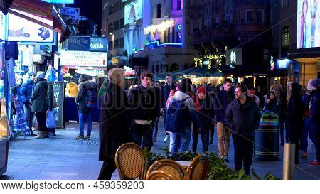 People Walking Uber Leicester Square By Night - London, United Kingdom - December 10, 2019