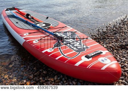 12.07.2022 Krasnoyarsk, Russia. Red Sup Board On The River Bank. Paddle Board On The Lake Shore. Sup