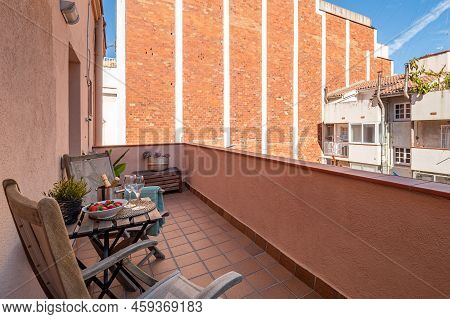 Leisure Area On A Balcony In A City Apartment With Buldings Around. Overbuilding Problem Concept.