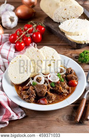 Czech Traditional Recipe For Beef Goulash With Homemade Dumpligs, Served In Simple Rustic Style