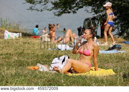Moscow, Russia - August 2022: People Sunbathing On A Beach On Background Of Moscow River In Strogino
