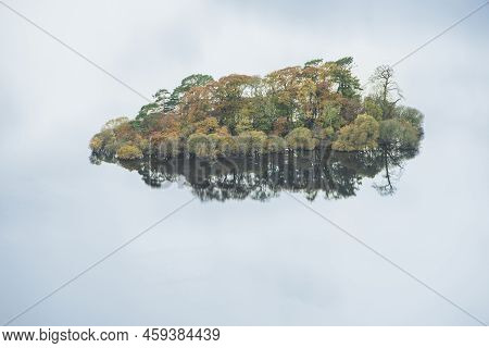 Abstract Landscape Autumn Image Of View Of Islands In Derwentwater With Sky Reflections Isolating Th