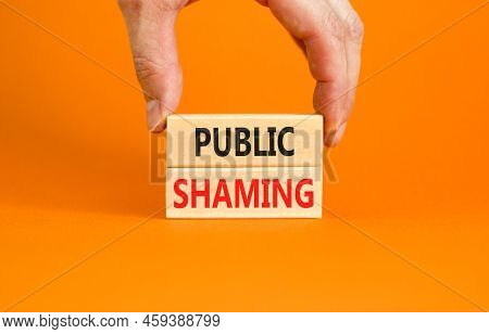 Public Shaming Symbol. Concept Words Public Shaming On Wooden Blocks On A Beautiful Orange Table Ora