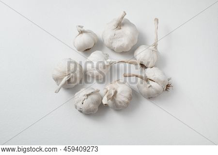 Garlic Cloves And Bulb On White Table