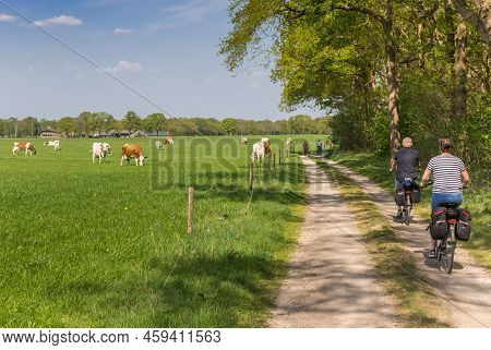 Couple Riding Their Bicycle At A Dirt Road In Overijssel, Netherlands