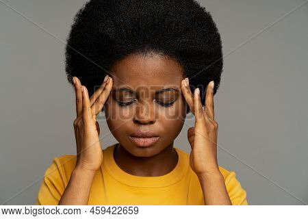 Tired Black Young Woman In Yellow T-shirt Feels Lack Of Concentration After Long Work In Office. Afr