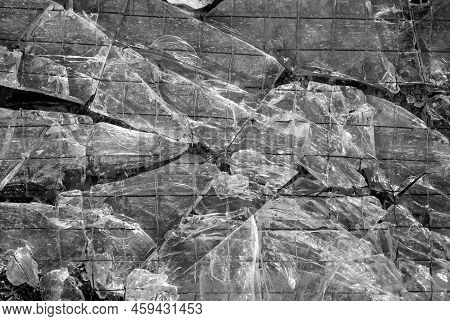 A Broken Glass With Metal Grid. Glass Breakage Texture.