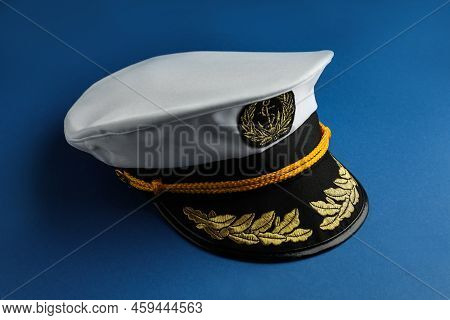 Peaked Cap With Accessories On Blue Background