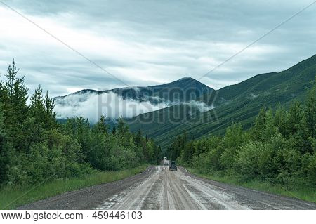 Polebridge, Montana - July 3, 2022: Dusty, Muddy Wet Dirt Road Leading To Polebridge Montana From Gl