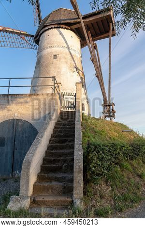 Early In The Morning There Is A Beautiful Windmill Whit The Sun Rising In The Sky