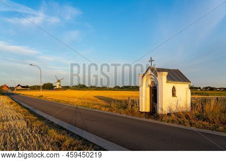 Early In The Morning There Is A Beautiful Windmill Whit The Sun Rising In The Sky