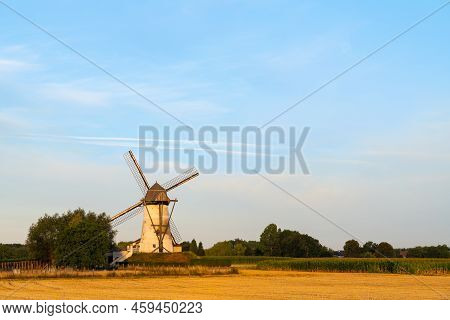 Early In The Morning There Is A Beautiful Windmill Whit The Sun Rising In The Sky