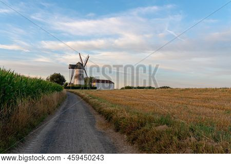 Early In The Morning There Is A Beautiful Windmill Whit The Sun Rising In The Sky