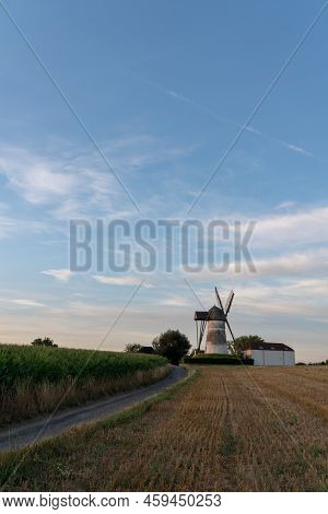 Early In The Morning There Is A Beautiful Windmill Whit The Sun Rising In The Sky