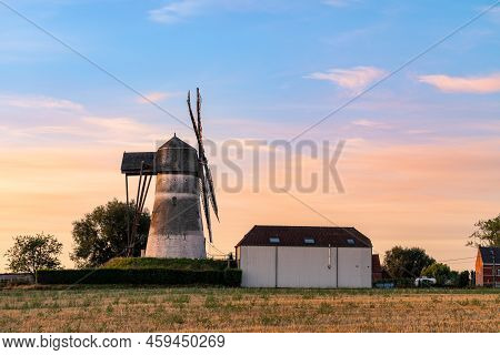 Early In The Morning There Is A Beautiful Windmill Whit The Sun Rising In The Sky