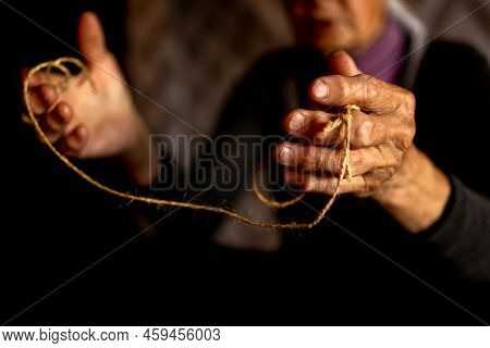 Hands Of Old Woman With Polyarthritis Disease. Canvas Strings On Fingers Of Elderly Lady, Puppets. H